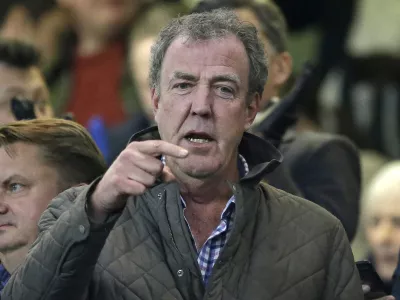 FILE - This is a Wednesday, March 11, 2015 file photo of TV host Jeremy Clarkson as he gestures as he takes his place in the stands before the Champions League round of 16 second leg soccer match between Chelsea and Paris Saint Germain at Stamford Bridge stadium in London. The BBC said Wednesday March 25, 2015 that it has decided not to renew the contract of "Top Gear'' host Jeremy Clarkson after a fracas with his producer. (AP Photo/Matt Dunham, File)
