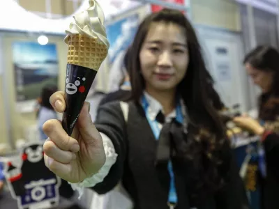 SHANGHAI, Nov. 10, 2019 A visitor shows a soy source-flavored ice cream from Japan at the Food and Agricultural Products exhibition area during the second China International Import Expo (CIIE) in Shanghai, east China, Nov. 8, 2019. The second CIIE was held from Nov. 5 to Nov. 10 at the National Exhibition and Convention Center in Shanghai.,Image: 482079668, License: Rights-managed, Restrictions:, Model Release: no 