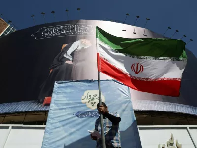 A man holds an Iranian flag on a street, after U.S. and Iranian officials said they had reached a deal to end their war and reopen the Strait of Hormuz, in Tehran, Iran, June 15, 2026. Majid Asgaripour/WANA (West Asia News Agency) via REUTERS  ATTENTION EDITORS - THIS PICTURE WAS PROVIDED BY A THIRD PARTY. ISRAEL OUT. NO COMMERCIAL OR EDITORIAL SALES IN ISRAEL. NO ACCESS FOR ISRAELI MEDIA. NO USE BBC PERSIAN. NO USE VOA PERSIAN. NO USE MANOTO. NO USE IRAN INTERNATIONAL. NO USE RADIO FARDA. DIGITAL: NO USE BBC PERSIAN. NO USE VOA PERSIAN. NO USE MANOTO. NO USE IRAN INTERNATIONAL. NO USE RADIO FARDA.