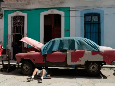 A man works on a classic American car in Havana, Cuba, Wednesday, June 17, 2026. (AP Photo/Jorge Luis Banos)