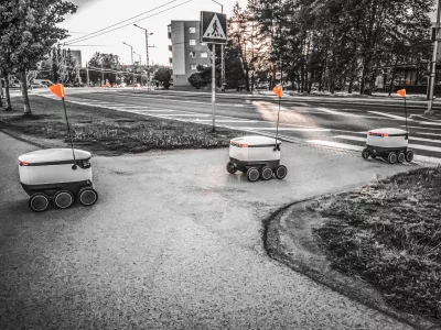 Some Delivery robots on the street. Estonian Cyber-couriers in Tallinn city. Sunny summer day. Copy space. Fitered image. the concept of new technology.