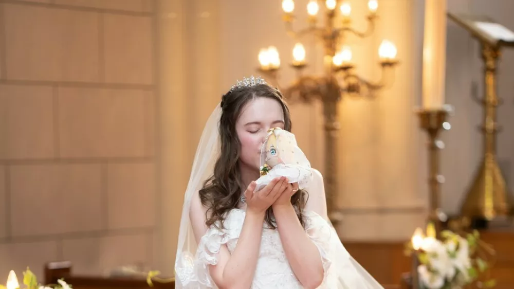 Story from Jam Press (Marry Cartoon Character)Pictured: Lucie Nanami's wedding day.'People call me delusional after I married a CARTOON character but I've spent THOUSANDS declaring my love'Woman weds fictional cartoon character in '2D solo wedding' and claps back at trolls calling her 'delusional'A woman has revealed how she's often called 'delusional' after marrying her favourite cartoon character &ndash; and says professing her love has cost thousands.As soon as Lucie Nanami touched down in Japan, her life changed as she knew it forever.The 24-year-old instantly fell in love with the culture, the people, and, most of all, manga cartoon characters.So much so that she began learning the language before studying at university, where she had a stint living there as an exchange student.And, while adapting to busy life in Tokyo, she met the love of her life.The pair went on to wed in a small ceremony &ndash; but there was one issue; her wife wasn't real."I'd never seen an anime rom-com before and I was totally obsessed," the office worker told creatorzine.com."But it was the character of Mami that particularly appealed to me."Though she was kind of the villain of the series, I admired her confidence."She had the other characters in the palm of her hand, which I found really attractive."I'd known I was a lesbian since I was a teenager and I just couldn't stop thinking about her."Lucie, who is originally from France, found a passion for manga, a Japanese style of comics, during her initial trip in 2015.During her second year of university, in 2021, she spotted a poster for the TV anime show called Rent-a-Girlfriend, in which her aforementioned future wife was one of the main characters.It follows the story of a student from Tokyo and his romantic escapades.Lucie began buying Mami-based merchandise and quickly built up an impressive collection including plush dolls, acrylic figurines, artwork &ndash; and even a life-size cutout.It set her back a whopping,000 (USD).But, for Lucie, Mami was an integral part of her life and she would take her everywhere with her.She said: "From family dinners, to the beach, Mami was always with me."It just felt right."I pick most of my clothes based on things that remind me of her and I choose the restaurants I go to to match her merchandise. "On her 21st birthday, her friends and family joined her for a celebration.But it wasn't just a birthday party &ndash; it was her engagement soire&eacute; to Mami.She said: "Both my parents and friends were supportive."I love Mami and I wanted to celebrate that."In 2024, Lucie obtained a working visa and moved to Tokyo full-time in a bid to spend the rest of her life with Mami.But then, she met Kaori, 27.She said: "I had started meeting up with like-minded people at local cafes to chat about manga."After six months, I began dating a girl called Kaori."I still loved Mami, but I didn't think my relationship with her should stop me from pursuing a real-life relationship, too."Of course, I told Kaori all about Mami and she wasn't jealous at all."In August 2025, she posted about her two-year engagement.And it caught the attention of Sun Euro, who offer solo ceremonies, and were branching out into 2D-weddings between people and fictional characters.They reached out to offer Lucie the wedding of her dreams.She said: "I said yes immediately."It was so exciting."Just four months later, it was the big day.After getting her hair and makeup done, she and Mami &ndash; the plushie version &ndash; were fitted into their bespoke bridal gowns.Sadly, her parents and real-life girlfriend, Kaori, were unable to attend.Lucie said: "My parents really wanted to be there, but they couldn't make it at such short notice."And Kaori couldn't get the time off work."But they watched it all unfold on Zoom."I read my vows in Japanese and asked her to let me always be by her side."I know she's a fictional character and I don't need her to love me back."But I wanted my vows to reflect my real emotions."It was a beautiful ceremony and it felt amazing to reaffirm what Mami means to me."While the ceremony wasn't legally binding, Lucie felt tied to her new wife in a spiritual sense.She shared the day on social media, @?hikari.sunshine, racking up over four million views and 587,000 likes.Sadly, it wasn't only met with well wishes.She said: "People were accusing me of being delusional."I know Mami isn't real &ndash; but why does that mean I can't love her?"We're not harming anyone."People might find my situation strange."But who says I shouldn't do what makes me happy?"She hopes to one day tie the knot &ndash; legally &ndash; to a real-life woman.Though it's important they accept Mami.Lucie added: "Life is brighter when you're open and proud about what you love."ENDSEDITOR'S NOTE: All press are kindly requested to include mention of the case study's Instagram handle somewhere in the copy and digital press are requested to link to this: https://www.instagram.com/hikari.sunshine/Exclusive Licence: An exclusive licence has been obtained directly from the verified copyright holder. Jam Press holds exclusive distribution rights for the agreed content within the terms of the contributor agreement.,Image: 1107842346, License: Rights-managed, Restrictions: EDITOR'S NOTE: All press are kindly requested to include mention of the case study's Instagram handle somewhere in the copy and digital press are requested to link to this: https://www.instagram.com/hikari.sunshine/Exclusive Licence: An exclusive licence, Model Release: no 