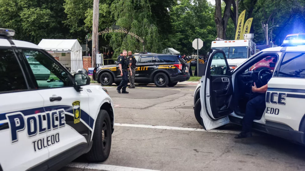 Toledo police investigates a shooting that left 12 people injured at the Old West End Festival at the Agnes Reynolds Jackson Arboretum in Toledo, Ohio on Saturday, June 6, 2026. (Rebecca Benson/The Blade via AP)