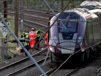 Emergency personnel work on a train on the tracks outside Bedford, England, after a train from Corby to London St. Pancras and another from Nottingham to London St. Pancras, collided on Friday June 19, 2026. (Jamie Lashmar/PA via AP)