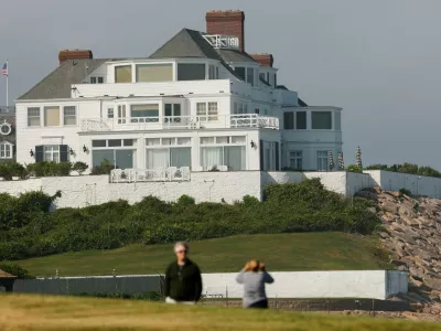 Visitors walk the lawn at Watch Hill Lighthouse and look towards the home of singer and songwriter Taylor Swift in the Watch Hill neighborhood in Westerly, Rhode Island, U.S., June 18, 2026. REUTERS/CJ Gunther