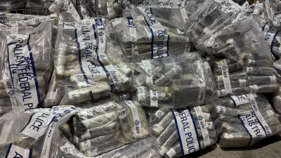 In this undated photo provided by the Australian Federal Police, a quantity of cocaine is bagged and displayed in Sydney. (Australian Federal Police via AP)