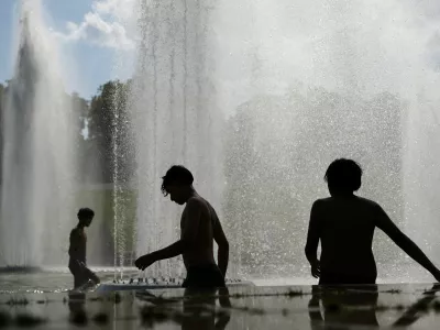 Children cool off in the Trocadero Fountain next to the Eiffel Tower in Paris as temperatures rise during a heatwave affecting a large part of France, June 22, 2026. REUTERS/Abdul Saboor