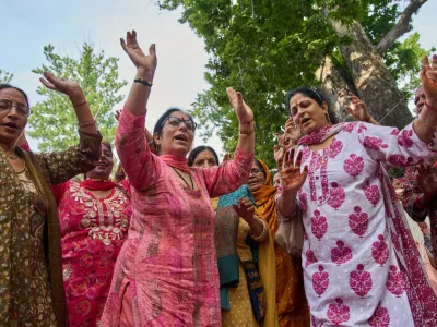 Hindu devotees dance as they sing religious songs during the annual festival dedicated to Hindu goddess Durga at the Kheer Bhawani temple in Tulla Mulla, northeast of Srinagar, Indian controlled Kashmir, Monday, June 22, 2026. (AP Photo/Dar Yasin)