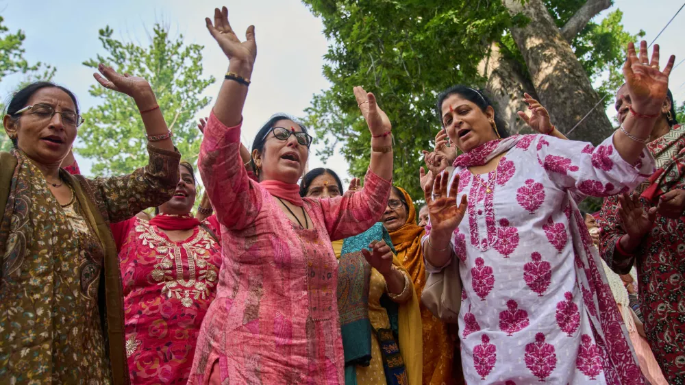 Hindu devotees dance as they sing religious songs during the annual festival dedicated to Hindu goddess Durga at the Kheer Bhawani temple in Tulla Mulla, northeast of Srinagar, Indian controlled Kashmir, Monday, June 22, 2026. (AP Photo/Dar Yasin)