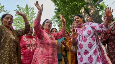 Hindu devotees dance as they sing religious songs during the annual festival dedicated to Hindu goddess Durga at the Kheer Bhawani temple in Tulla Mulla, northeast of Srinagar, Indian controlled Kashmir, Monday, June 22, 2026. (AP Photo/Dar Yasin)