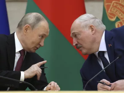 Russian President Vladimir Putin and Belarusian President Alexander Lukashenko talk during a signing ceremony following a meeting of the Supreme State Council of the Russia-Belarus Union State marking the 25th anniversary of the Union State Treaty in Minsk, Belarus, Friday, Dec. 6, 2024.(Gavriil Grigorov, Sputnik, Kremlin Pool Photo via AP)