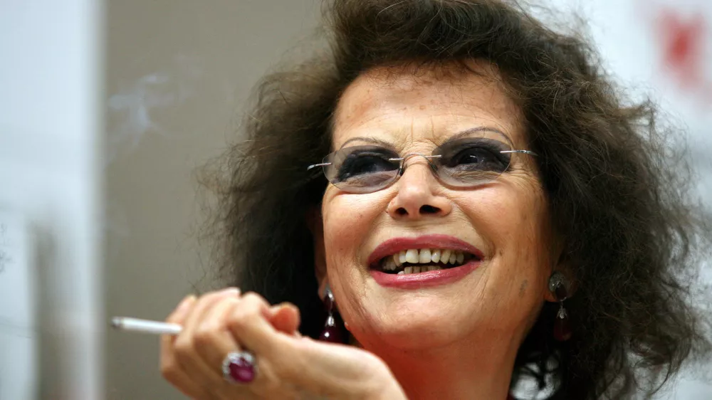 FILE PHOTO: Italian actress Claudia Cardinale smiles during a news conference in Cluj Napoca June 7, 2009. Cardinale received a lifetime award at the end of the eighth edition of the Transylvania International Film Festival (TIFF). REUTERS/Mircea Rosca (ROMANIA ENTERTAINMENT HEADSHOT)/File Photo