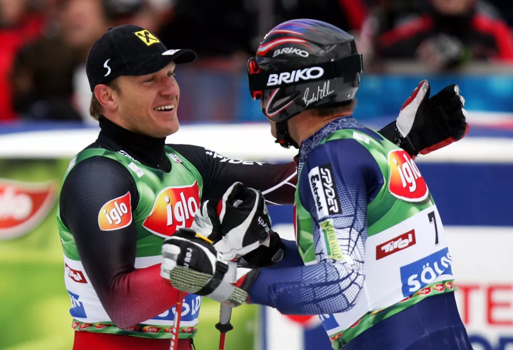 Hermann Maier of Austria gets congratulations from Bode Miller of the U.S. after winning the season opening Alpine Ski World Cup giant slalom race in the Tyrolean ski resort of Soelden Austria October 23, 2005. Maier won in a time of two minutes 17.60 seconds ahead of Miller of the U.S. and Rainer Schoenfelder of Austria. REUTERS/Dominic Ebenbichler