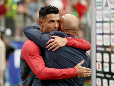 Soccer Football - FIFA World Cup 2026 - Group K - Portugal v Uzbekistan - Houston Stadium, Houston, Texas, U.S. - June 23, 2026 Portugal's Cristiano Ronaldo and coach Roberto Martinez celebrate after the match REUTERS/Phil Noble
