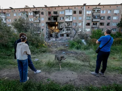 People look at a heavily damaged multi-storey residential building following an overnight attack, what Russian-installed authorities called a Ukrainian drone strike, in the course of the Russia-Ukraine conflict in the town of Horlivka (Gorlovka) in the Donetsk region, a Russian-controlled area of Ukraine, June 24, 2026. REUTERS/Alexander Ermochenko