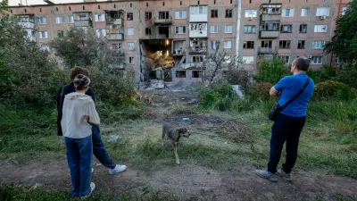 People look at a heavily damaged multi-storey residential building following an overnight attack, what Russian-installed authorities called a Ukrainian drone strike, in the course of the Russia-Ukraine conflict in the town of Horlivka (Gorlovka) in the Donetsk region, a Russian-controlled area of Ukraine, June 24, 2026. REUTERS/Alexander Ermochenko