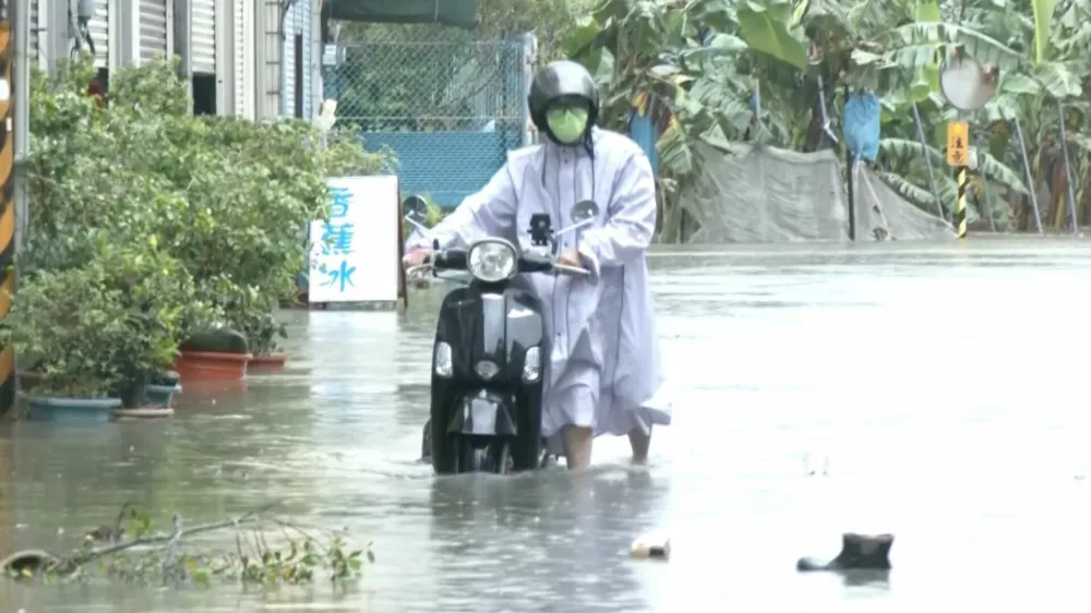 A man with a scooter moves in the floodwater during heavy rains caused by the nearby passing of typhoon Mekkhala, as it heads towards Japan, in Kaohsiung, Taiwan, June 25, 2026. CTS via REUTERS TV/via REUTERS  THIS IMAGE HAS BEEN SUPPLIED BY A THIRD PARTY. NO RESALES. NO ARCHIVES. TAIWAN OUT. NO COMMERCIAL OR EDITORIAL SALES IN TAIWAN. MANDATORY CREDIT.