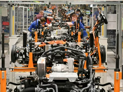 FILE PHOTO: Technicians work at the production line for electric car models of the Volkswagen Group, in Zwickau, Germany, April 26, 2022. REUTERS/Matthias Rietschel/File Photo