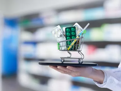 The concept of online medicine trading. The doctor shows a shopping cart with medicines on his tablet.