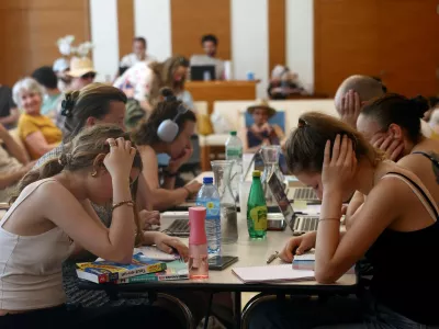 Middle school students work to prepare the "brevet des colleges" (middle school diploma) inside an air-conditioned room open to the public inside the 17th district city hall as temperatures rise in Paris, during a heatwave affecting a majority of the country, in France, June 25, 2026. REUTERS/Alice Sacco