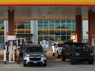 Customer fill up their vehicle's tank at a gas station in Buffalo Grove, Thursday, June 25, 2026. (AP Photo/Nam Y. Huh)