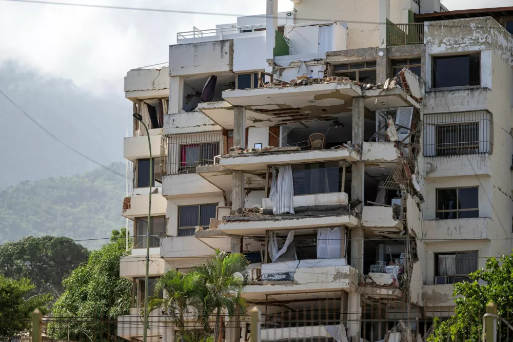A damaged building is seen from the base camp of the French Civil Security Training and Intervention Regiment (UIISC 7) at the Karting La Guaira complex in Caraballeda, La Guaira state, Venezuela, on June 27, 2026, as they assist with rescue operations following earthquakes. MIGUEL MEDINA/Pool via REUTERS