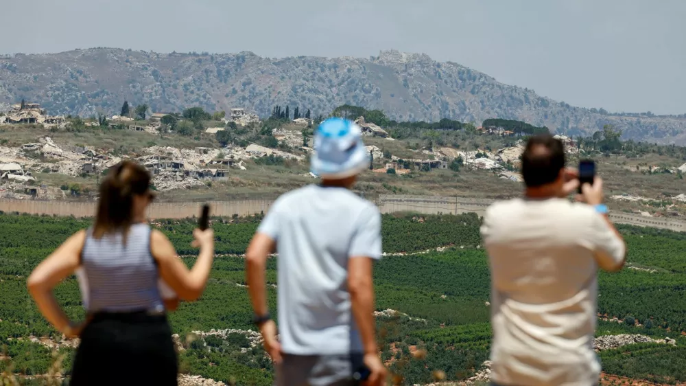 Israeli people hold mobile phones near the Israel-Lebanon border as they look towards Lebanon, after the two countries signed a framework agreement following U.S.-mediated talks, in Metula Israel, June 27, 2026. REUTERS/Amir Cohen