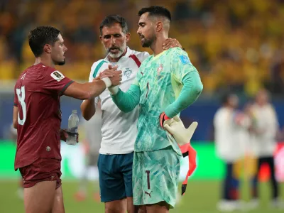 Portugal goalkeeper Diogo Costa (1) greets Pedro Neto after the World Cup Group K soccer match between Colombia and Portugal in Miami Gardens, Fla., Saturday, June 27, 2026. (AP Photo/Lynne Sladky)