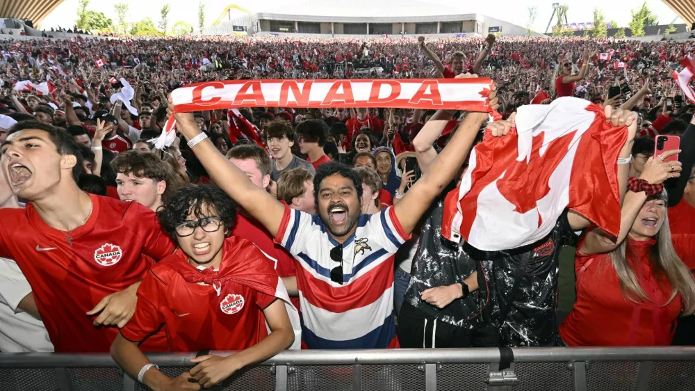 Soccer Football - FIFA World Cup 2026 - Round of 32 - South Africa v Canada - Fans gather in Vancouver - Vancouver, Canada - June 28, 2026 Canada fans celebrate at the Vancouver fan festival after Stephen Eustaquio scores their first goal REUTERS/Jennifer Gauthier