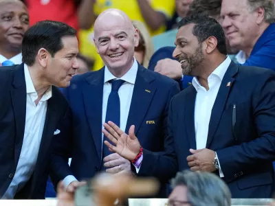 FIFA President Gianni Infantino, centre, stands with and United States Secretary of State Marco Rubio, left, and Director of the FBI, Kash Patel react ahead of the World Cup Group K soccer match between Colombia and Portugal in Miami Gardens, Fla., Saturday, June 27, 2026. (AP Photo/Rebecca Blackwell)