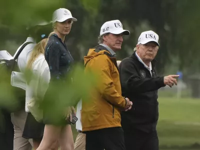 President Donald Trump, from right, Interior Secretary Doug Burgum and White House aide Natalie Harp tour the East Potomac Park golf course, Sunday, June 28, 2026, in Washington. (AP Photo/Mark Schiefelbein)