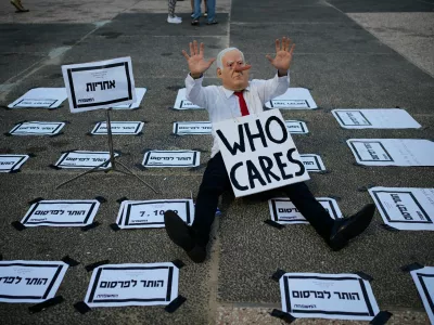 A demonstrator wears a mask depicting Israeli Prime Minister Benjamin Netanyahu during a rally marking 1,000 days to the deadly Oct. 7, 2023, Hamas-led attack on Israel, which sparked the war in Gaza, in Tel Aviv, Israel, Thursday, July 2, 2026. (AP Photo/Ohad Zwigenberg)