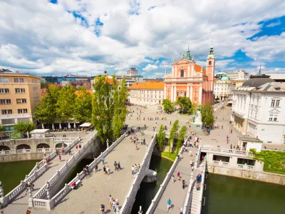 Romantic Ljubljana city center: river Ljubljanica, Triple Bridge (Tromostovje), Preseren square and Franciscan Church of the Annunciation; Ljubljana, Slovenia, Europe.