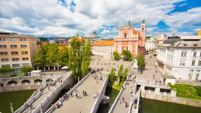 Romantic Ljubljana city center: river Ljubljanica, Triple Bridge (Tromostovje), Preseren square and Franciscan Church of the Annunciation; Ljubljana, Slovenia, Europe.