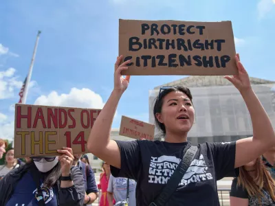 FILE - Hannah Liu, 26, of Washington, holds up a sign in support of birthright citizenship, May 15, 2025, outside of the Supreme Court in Washington. (AP Photo/Jacquelyn Martin, File)