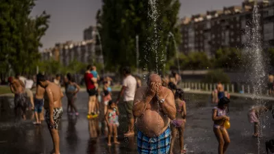 People cool off in an urban beach at Madrid Rio park in Madrid, Spain, Wednesday, July 13, 2022. Weather forecasters say Spain is expected to have its second heat wave in less than a month and that it will will last at least until the weekend. Meteorologists said an overheated mass of air and warm African winds are driving temperatures in the Iberian Peninsula beyond their usual highs. (AP Photo/Manu Fernandez)