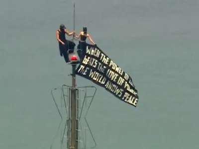 Two people display a banner atop the Empire State Building in the Manhattan borough of New York, U.S., July 1, 2026, in a still image from video. ABC Affiliate WABC via REUTERS. NO RESALES. NO ARCHIVES. THIS IMAGE HAS BEEN SUPPLIED BY A THIRD PARTY