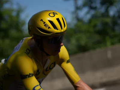 Slovenia's Tadej Pogacar, wearing the overall leader's yellow jersey, rides in the pack, during the fourth stage of the Tour de France cycling race over 181.9 kilometers (112.4 miles) with start in Carcassonne and finish in Foix, France, Tuesday, July 7, 2026. (AP Photo/Thibault Camus)