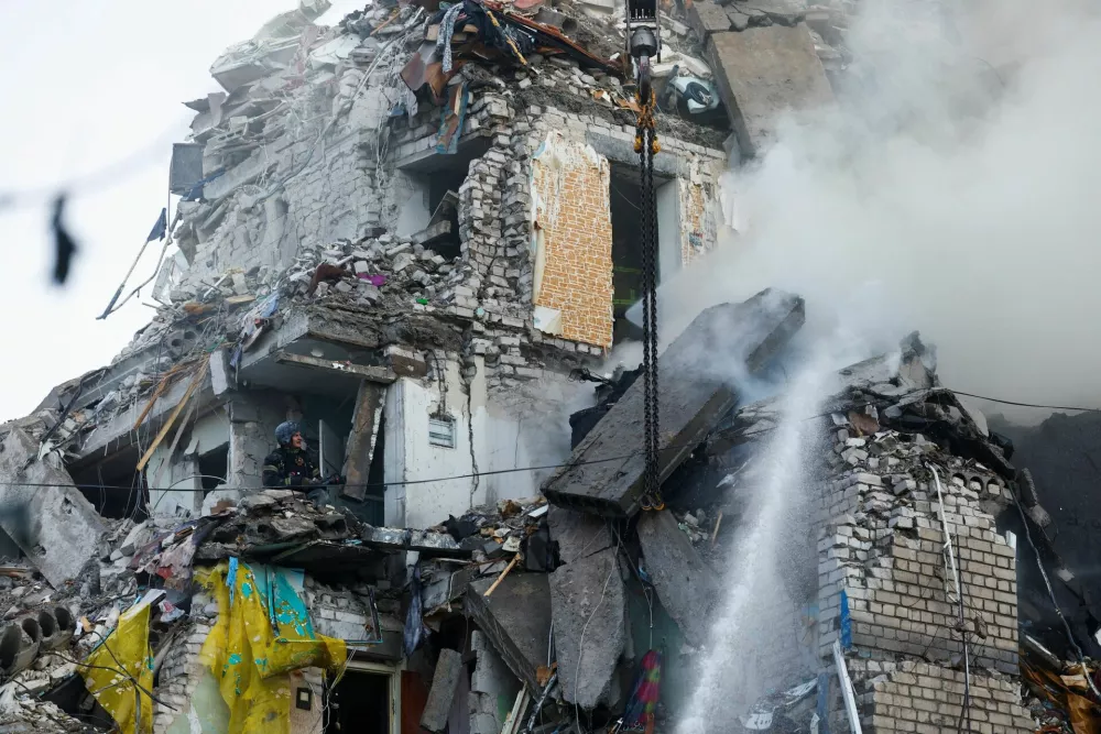 Rescuers work at the site of an apartment building damaged during overnight Russian missile and drone strikes, amid Russia's attack on Ukraine, in Kyiv, Ukraine, July 2, 2026. REUTERS/Valentyn Ogirenko