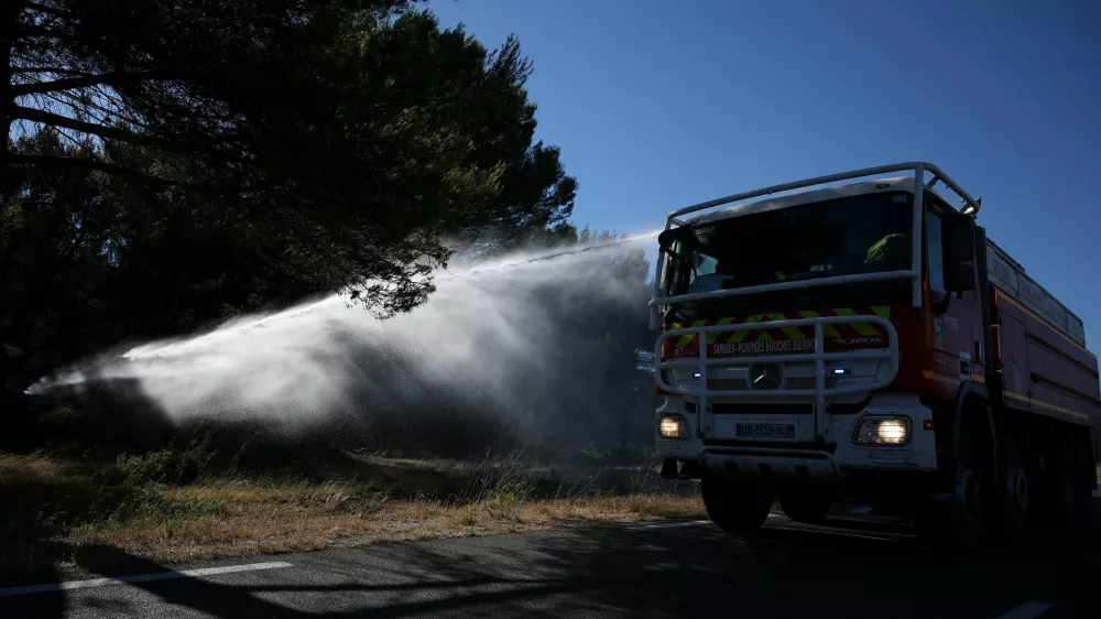 A fire truck sprays water to contain a wildfire in Lancon-Provence near Marseille, France, July 2, 2026. REUTERS/Manon Cruz
