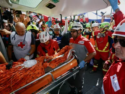Rescue workers transport survivor Hernan Alberto Gil, who was trapped for over a week at a collapsed mall following June 24 earthquakes, in La Guaira, Venezuela, July 2, 2026. REUTERS/Maxwell Briceno