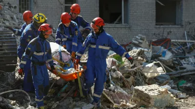 Rescuers carry the body of a killed person found under debris of an apartment building damaged during overnight Russian missile and drone strikes, amid Russia's attack on Ukraine, in Kyiv, Ukraine July 2, 2026. REUTERS/Valentyn Ogirenko   TPX IMAGES OF THE DAY