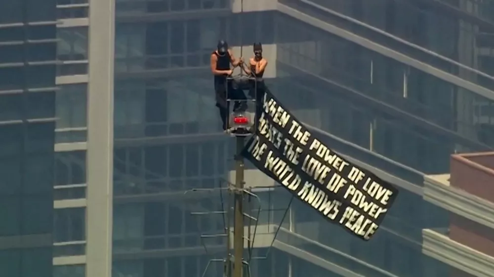 Two people display a banner atop the Empire State Building in the Manhattan borough of New York, U.S., July 1, 2026 in a still image from video. ABC Affiliate WABC/Handout via REUTERS. NO RESALES. NO ARCHIVES. THIS IMAGE HAS BEEN SUPPLIED BY A THIRD PARTY