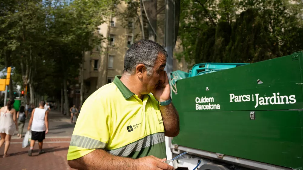 Antonio Reina, a worker, wears a heat-monitoring bracelet and wipes the sweat off while working. A year after one of its street cleaners died during a heatwave, the city of Barcelona has begun to use heat-monitoring bracelets for its outdoor workers to help prevent heat-related incidents in Barcelona, Spain, July 1, 2026. REUTERS/ Bruna Casas