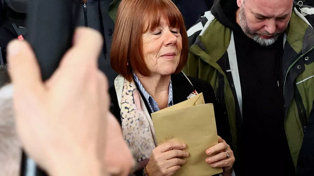 FILE PHOTO: Frenchwoman Gisele Pelicot, the victim of a mass rape orchestrated by her then-husband Dominique Pelicot at their home in the southern French town of Mazan, reacts as she leaves after the verdict in the trial for Dominique Pelicot and 50 co-accused, at the courthouse in Avignon, France, December 19, 2024. REUTERS/Manon Cruz/File Photo