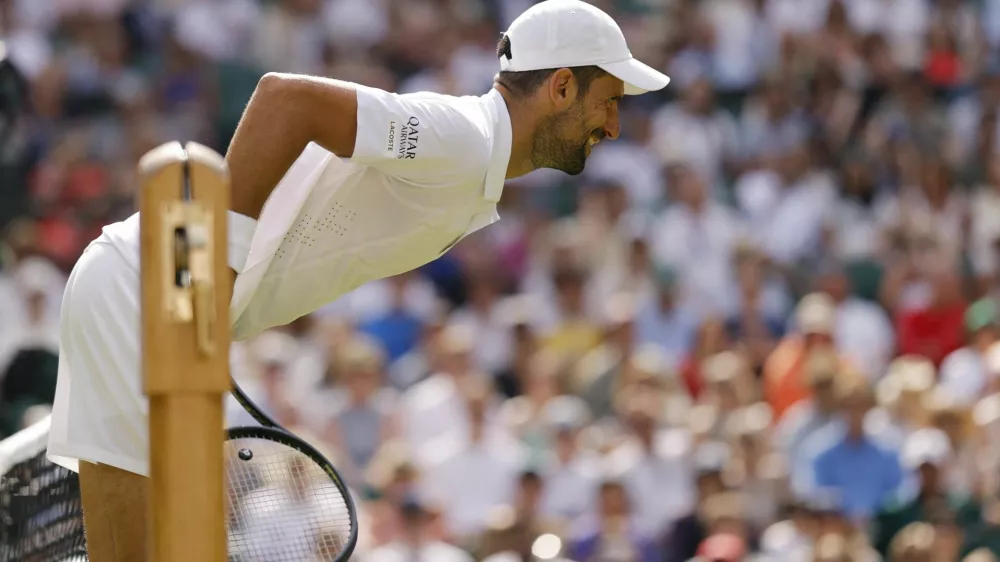 Tennis - Wimbledon - All England Lawn Tennis and Croquet Club, London, Britain - July 3, 2026 Serbia's Novak Djokovic leans over the net during his third round match against France's Arthur Rinderknech REUTERS/Andrew Couldridge