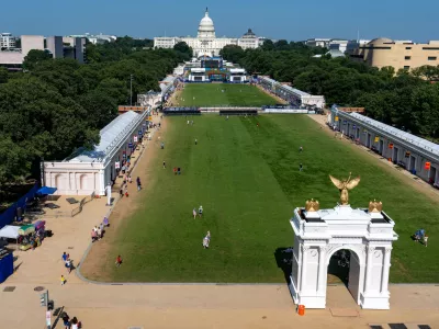 The U.S. Capitol and a model of the United States Triumphal Arch are seen at the Great American State Fair on the National Mall, Thursday, July 2, 2026, in Washington. (AP Photo/Alex Brandon)