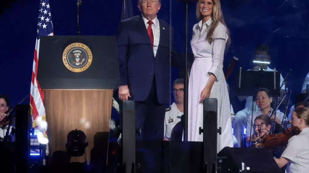 U.S. President Donald Trump and U.S. first lady Melania Trump stand onstage together after his remarks at a Fourth of July rally, marking the 250th anniversary of U.S. independence, on the National Mall in Washington, D.C., U.S., July 4, 2026. REUTERS/Jonathan Ernst