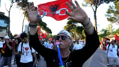 A protester takes part in a rally against plans for a luxury construction project linked to U.S. President Donald Trump's son-in-law, Jared Kushner, in Tirana, Albania, Saturday, July 4, 2026.(AP Photo/Hameraldi Agolli)