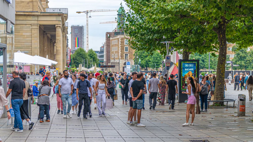Stuttgart, Germany, July 12, 2024: crowd of people tourists walking down pedestrian street King K&Atilde;&para;nigstra&Atilde;e Koenigstrasse and Castle Square Schlossplatz in old town Stuttgart historic city center